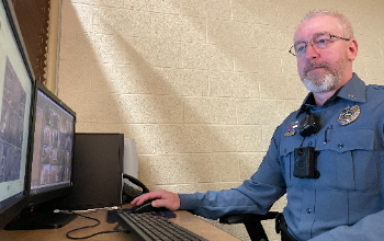 School Resource Officer Gerald Hockey reviews security cameras during his shift.