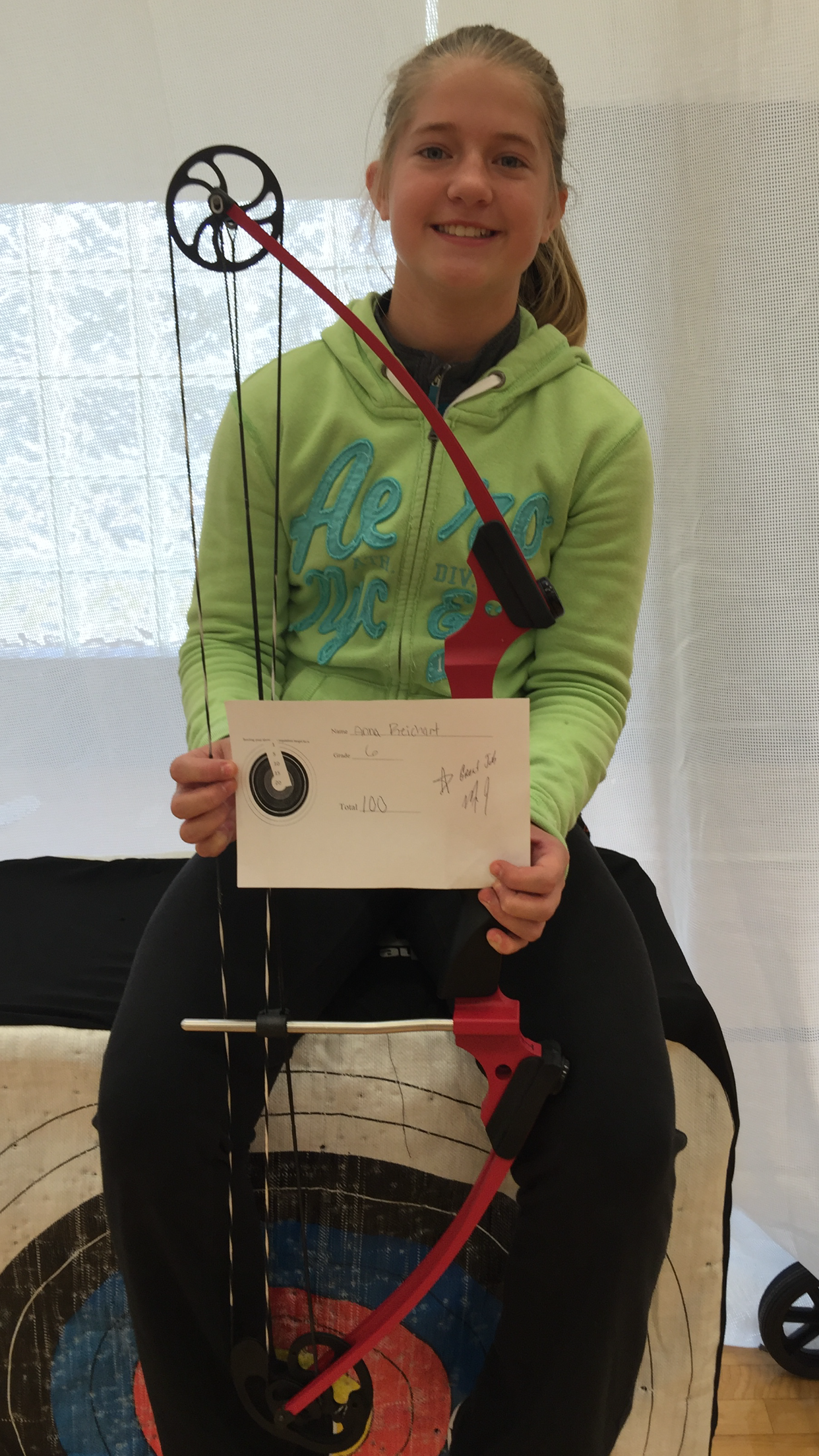 6th grader Anna Reichart scores a perfect 100 in archery class