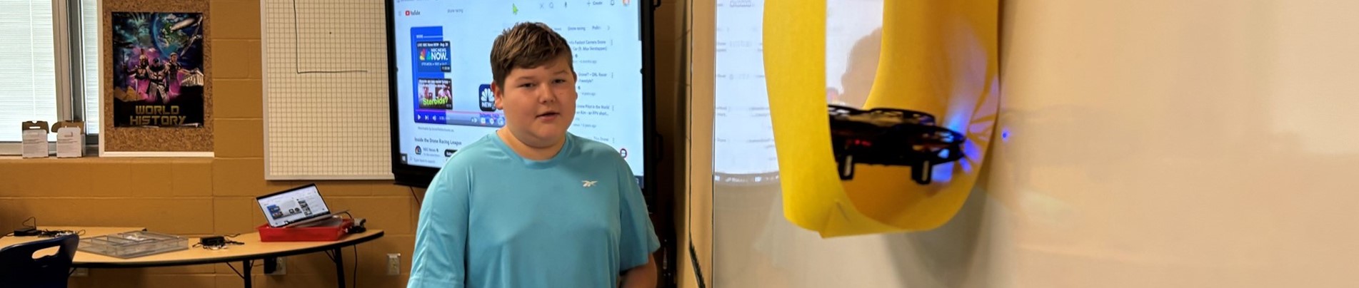 Students practice flying drones through obstacles in class!