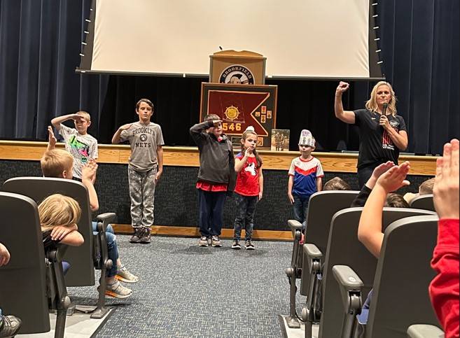 Maj. Sarah Kurpe teaches BES students how to salute
